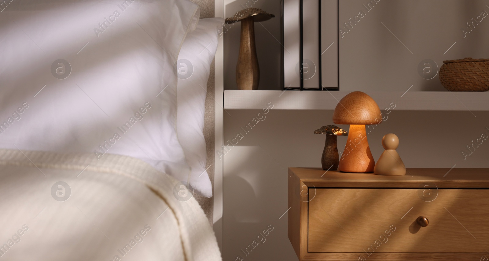 Photo of Stylish living room interior with bed, bedside table and night light