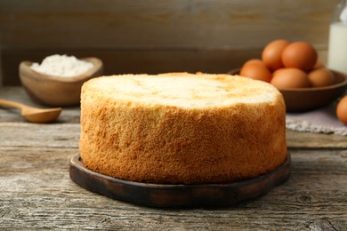 Photo of Tasty fresh sponge cake on wooden table