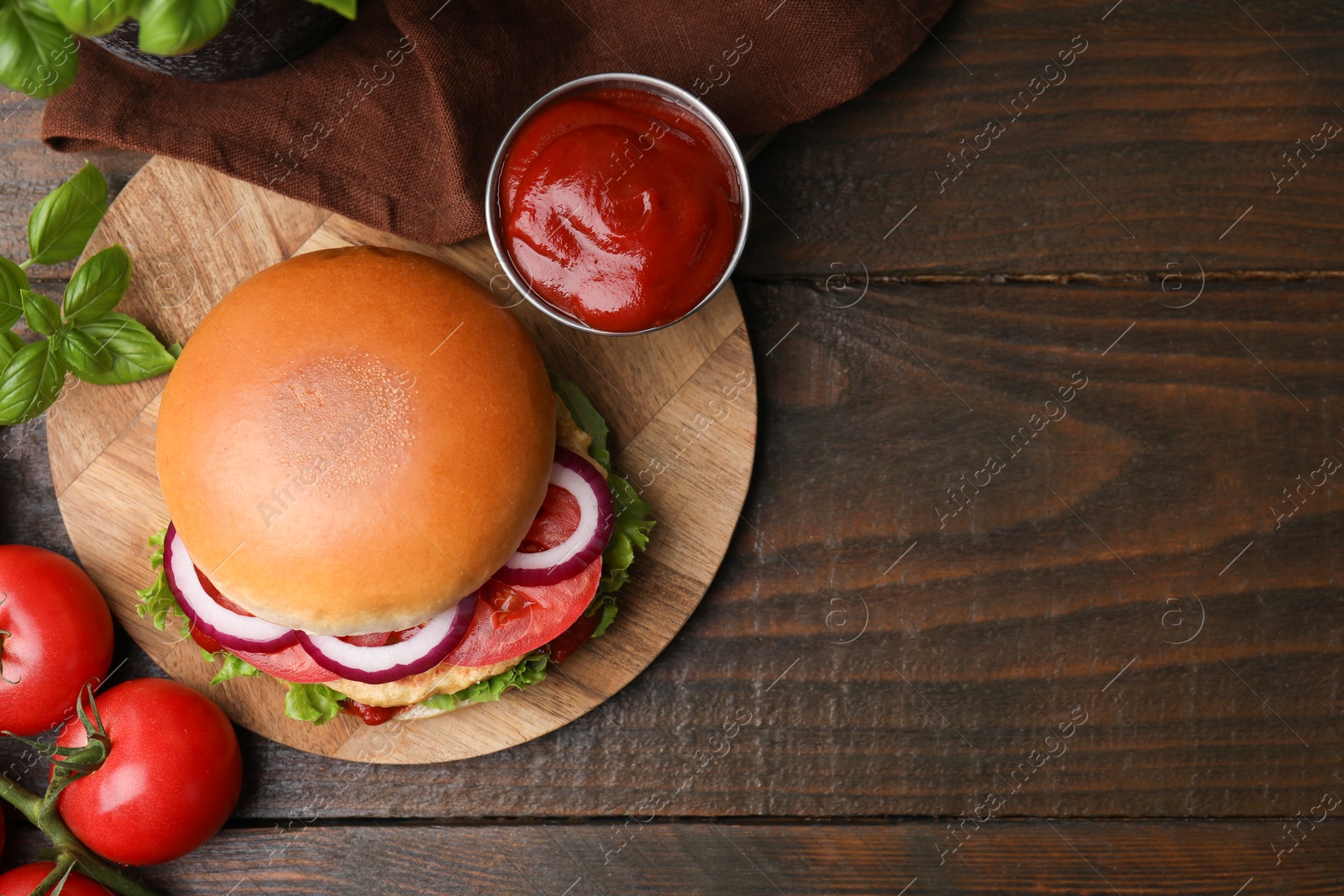 Photo of Delicious vegan burger with chickpea cutlet on wooden table, flat lay. Space for text