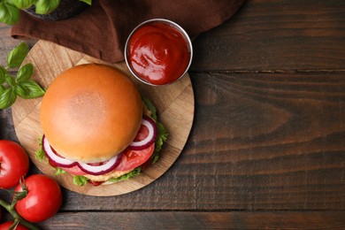 Delicious vegan burger with chickpea cutlet on wooden table, flat lay. Space for text