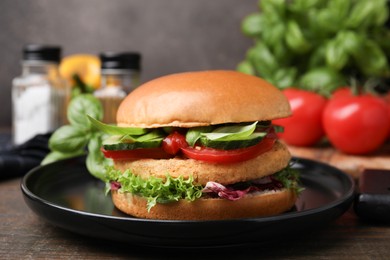 Photo of Delicious vegan burger with chickpea cutlet on wooden table, closeup