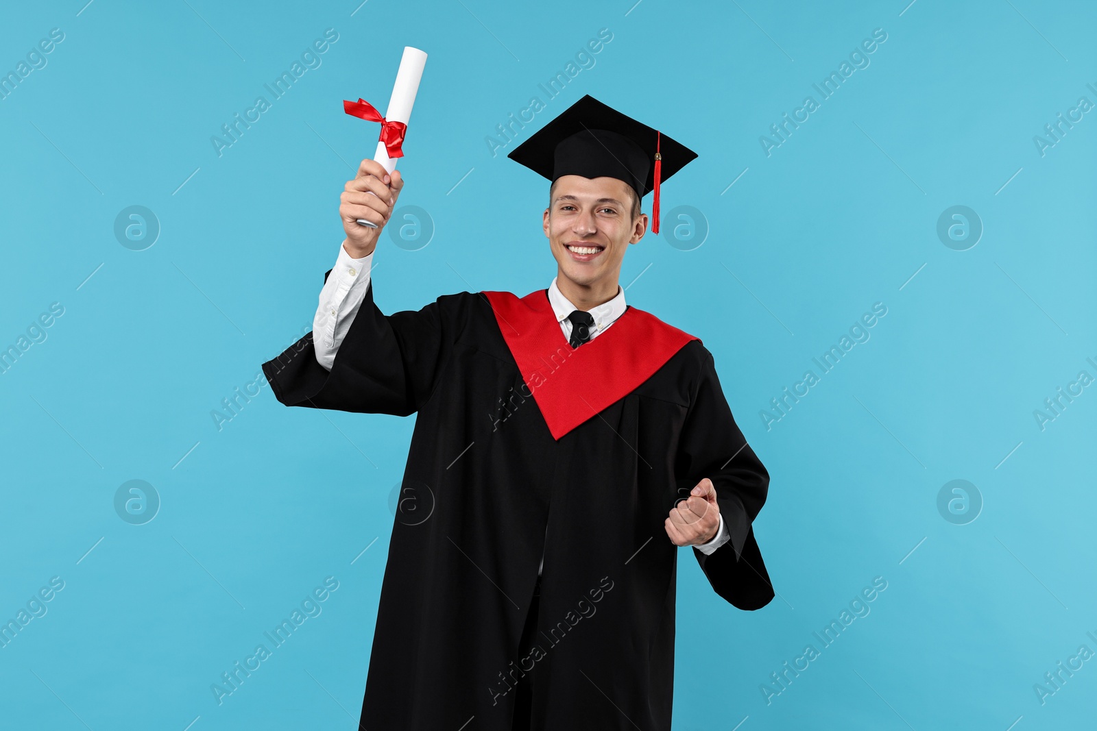 Photo of Happy student with diploma after graduation on light blue background