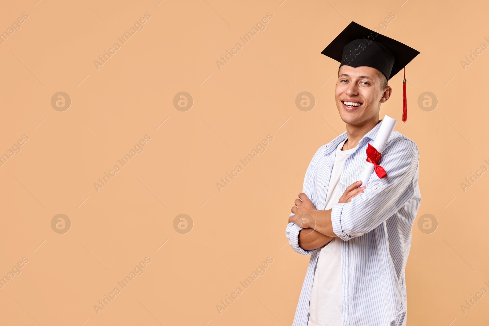 Photo of Happy student with diploma after graduation on beige background. Space for text