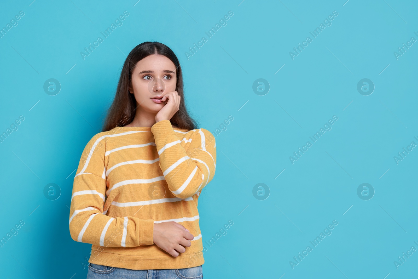 Photo of Stressful student before exam on light blue background, space for text