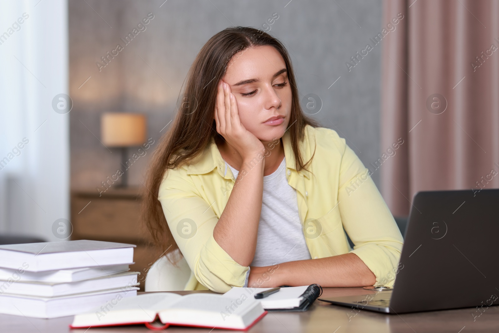 Photo of Young student having stress before exam at desk