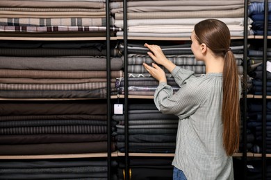 Young woman working in professional workshop, space for text