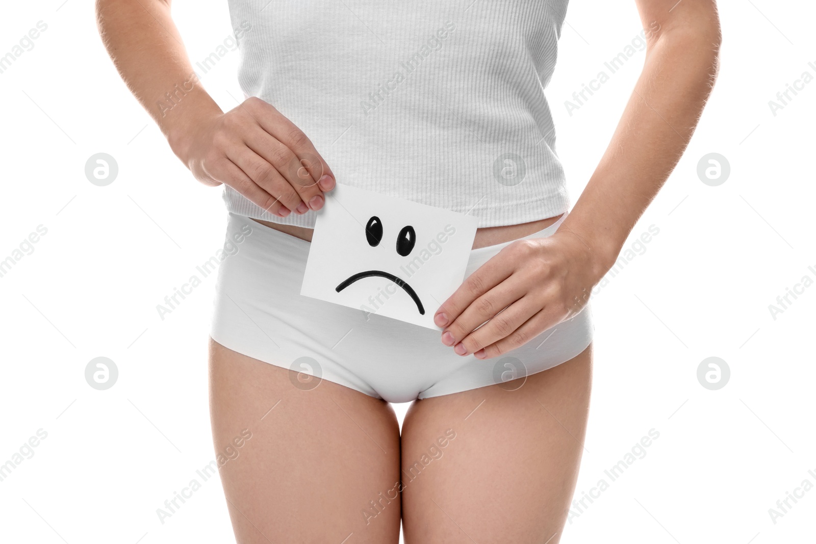 Photo of STD (sexually transmitted disease). Woman holding sticky note with drawn sad face on white background, closeup