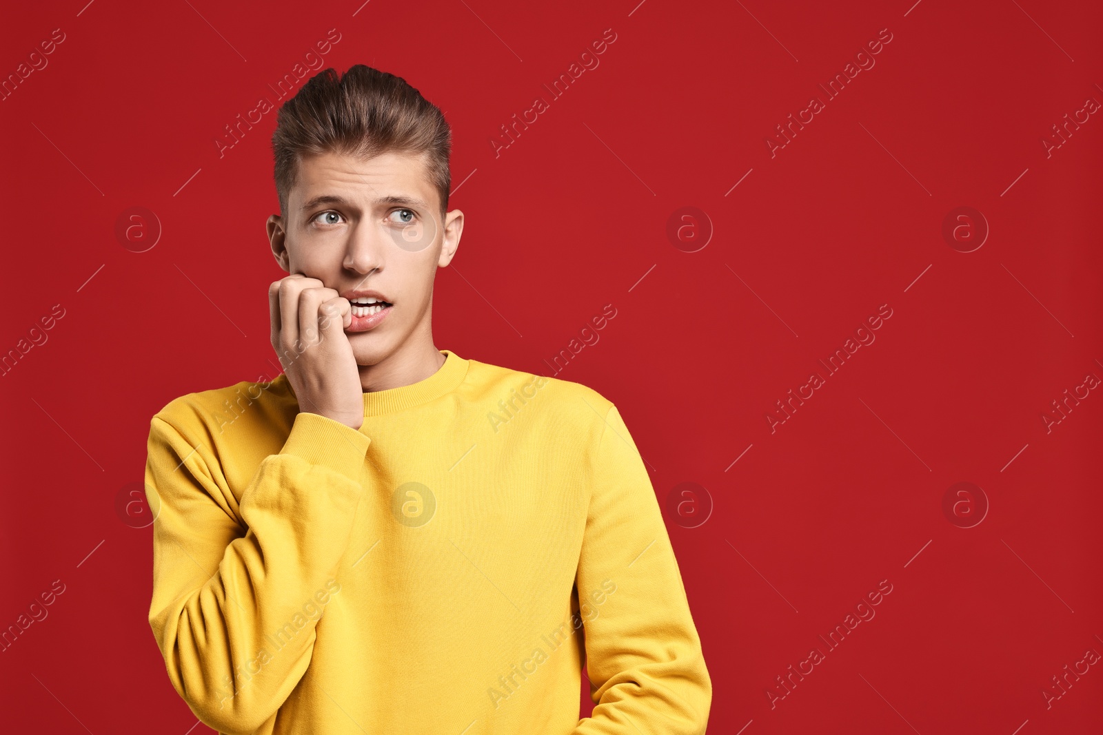 Photo of Emotional student having stress before exam on red background. Space for text