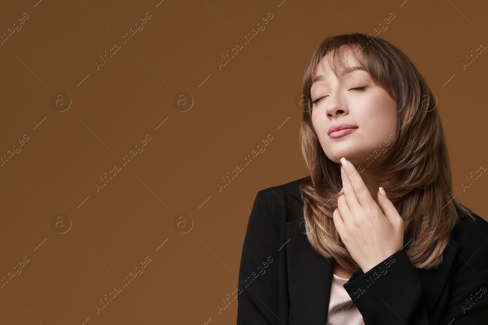 Photo of Attractive woman with stylish haircut on brown background, space for text