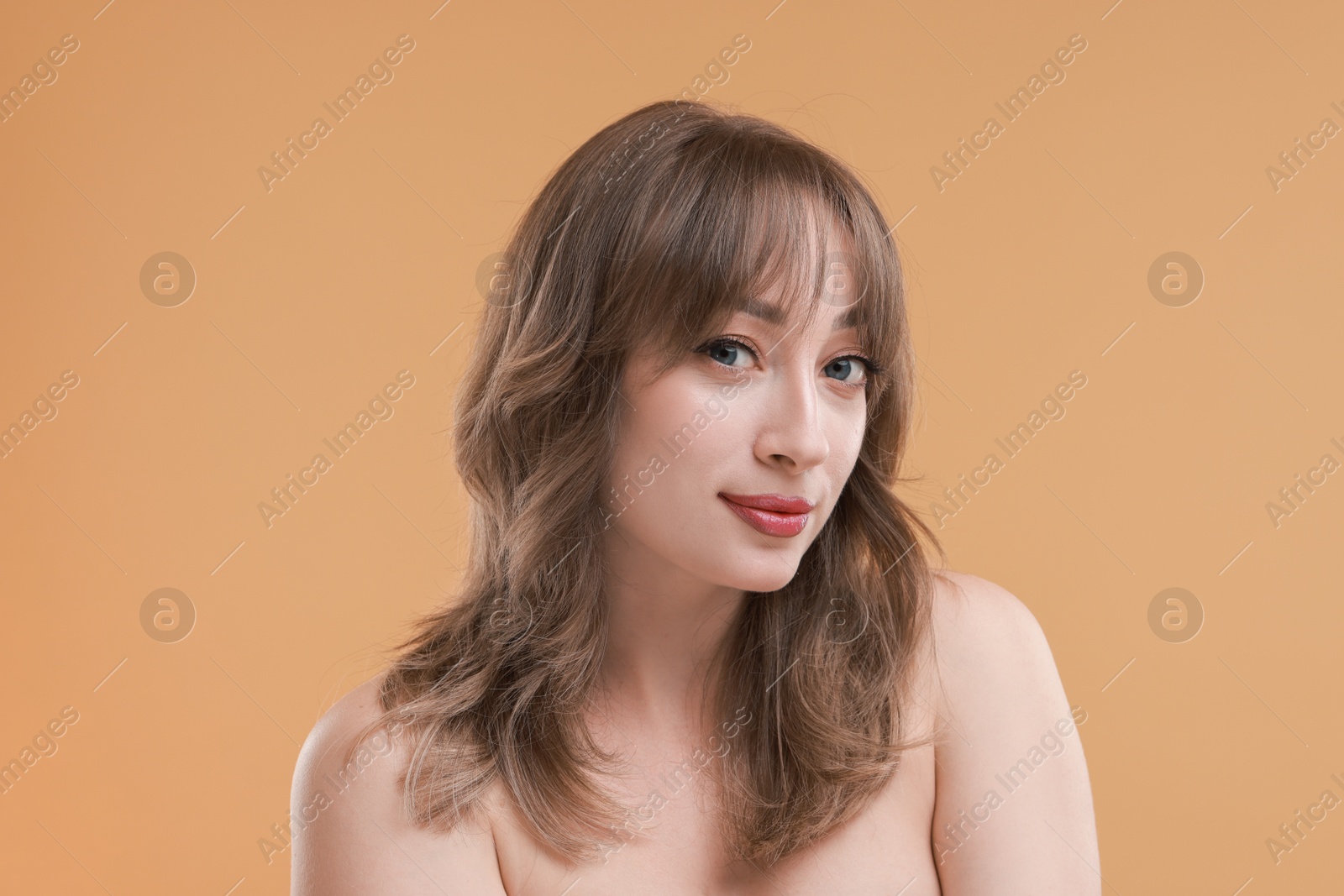 Photo of Attractive woman with stylish haircut on beige background