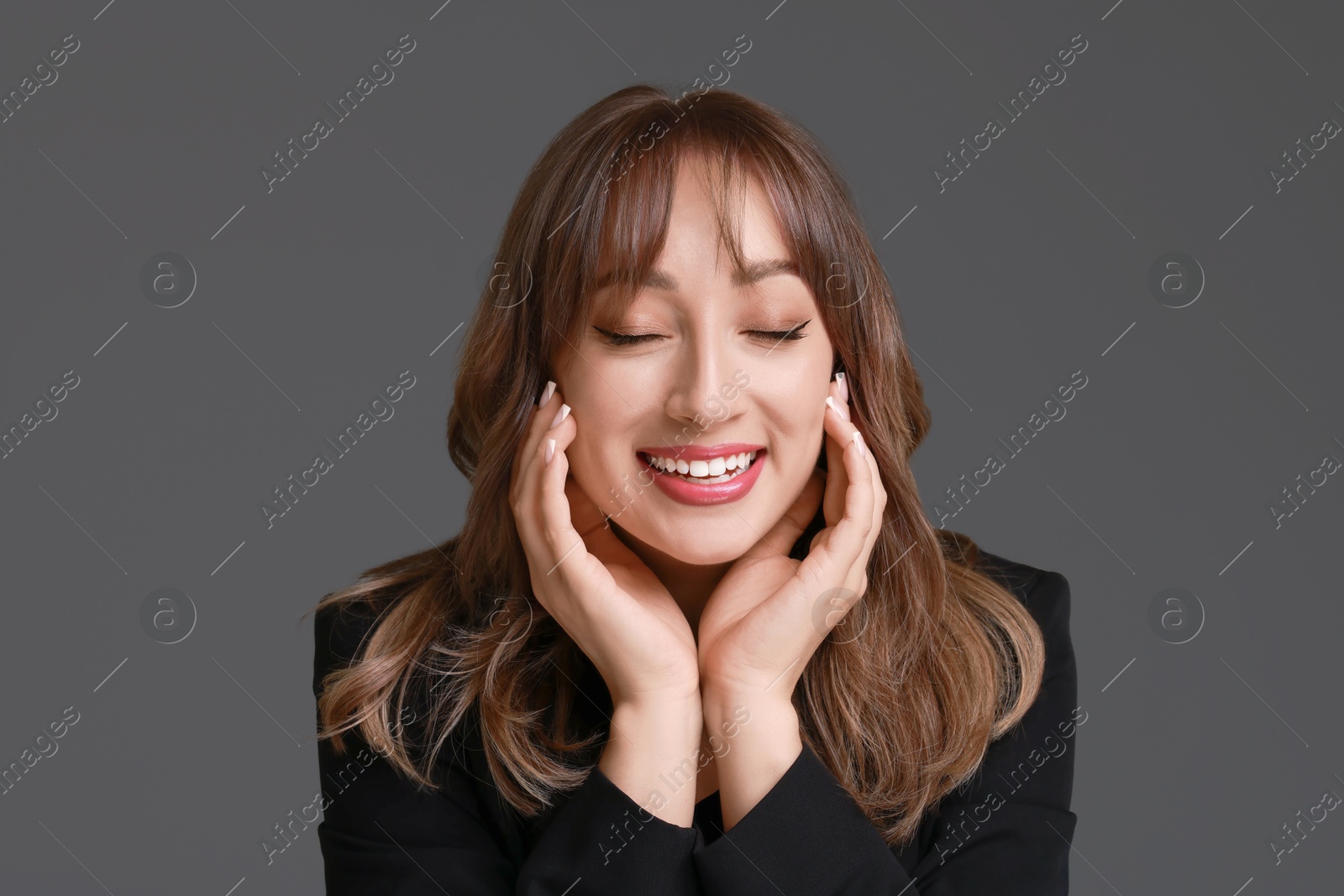 Photo of Attractive woman with stylish haircut on grey background