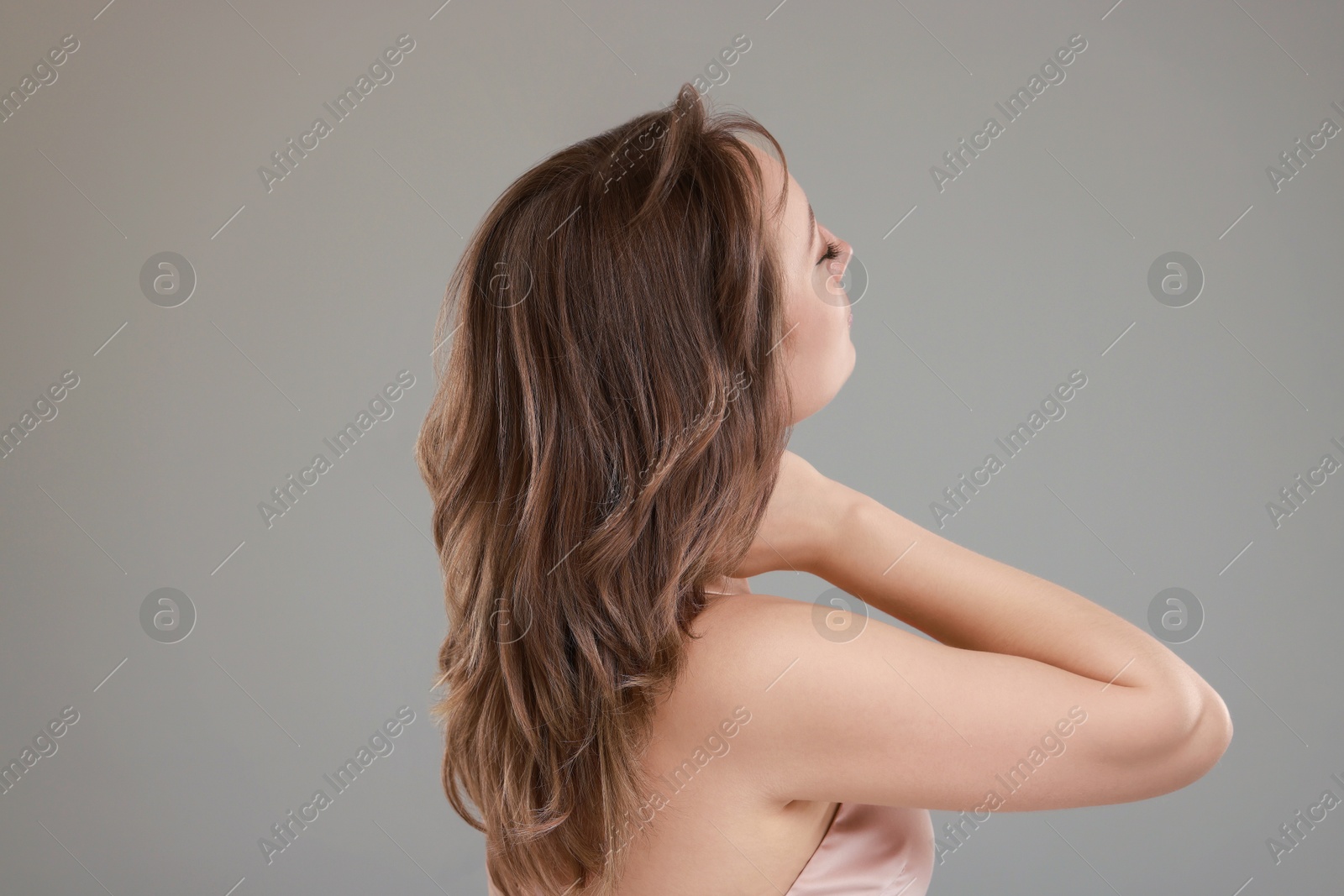 Photo of Woman with stylish haircut on grey background