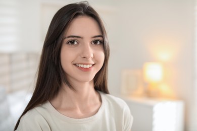 Photo of Portrait of happy teenage girl at home. Space for text