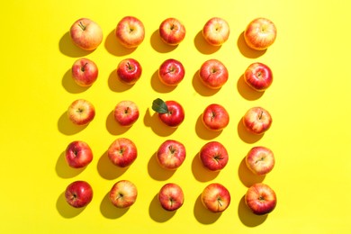 Photo of Flat lay composition with many red apples on yellow background