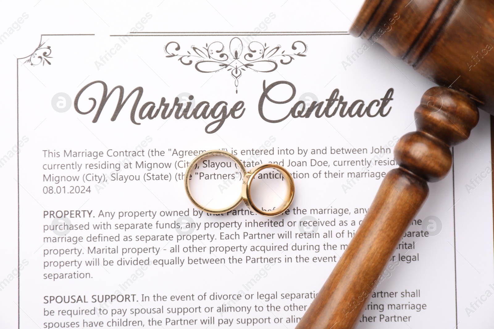 Photo of Marriage contract, gavel and golden rings, top view