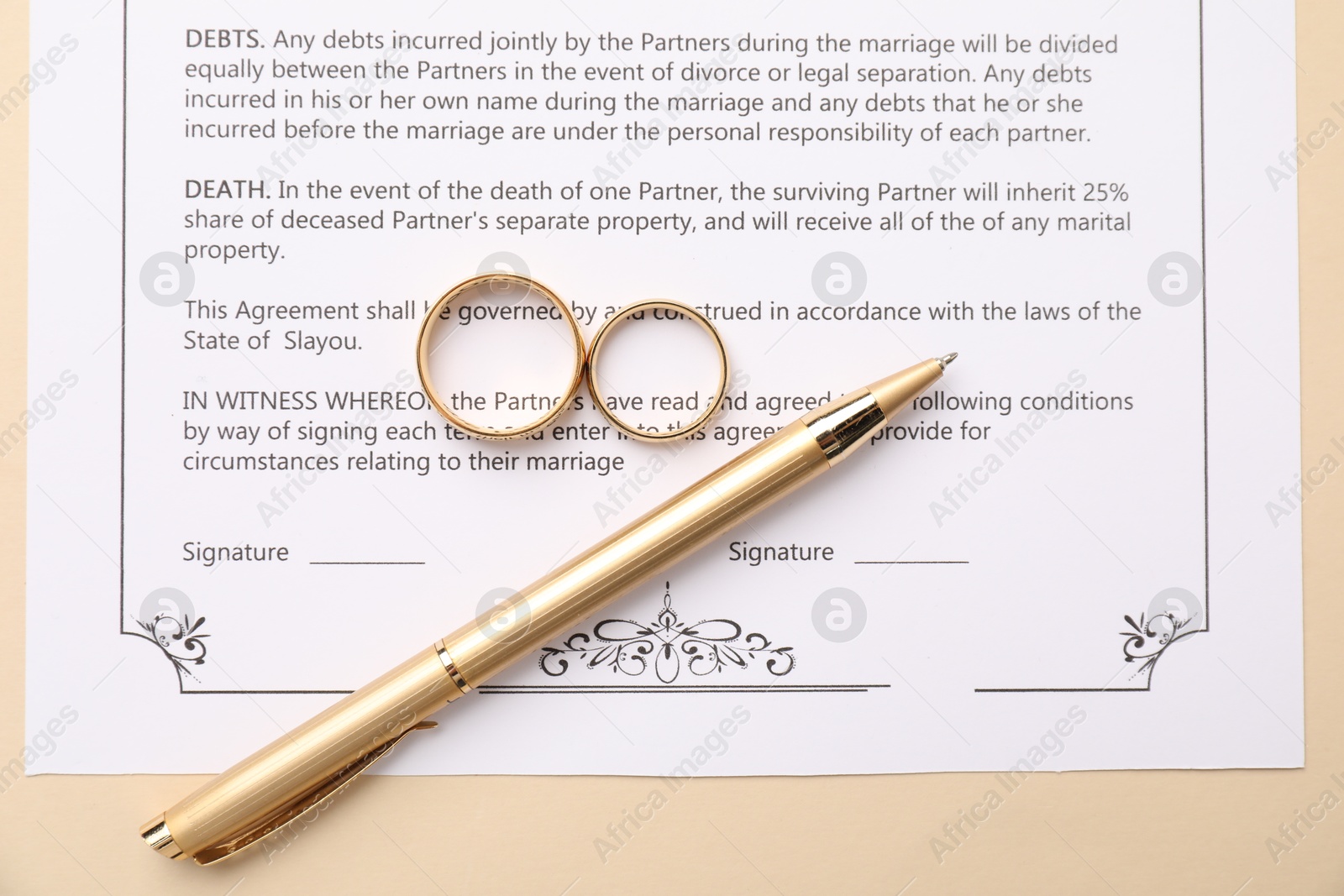 Photo of Marriage contract, pen and golden rings on beige background, top view