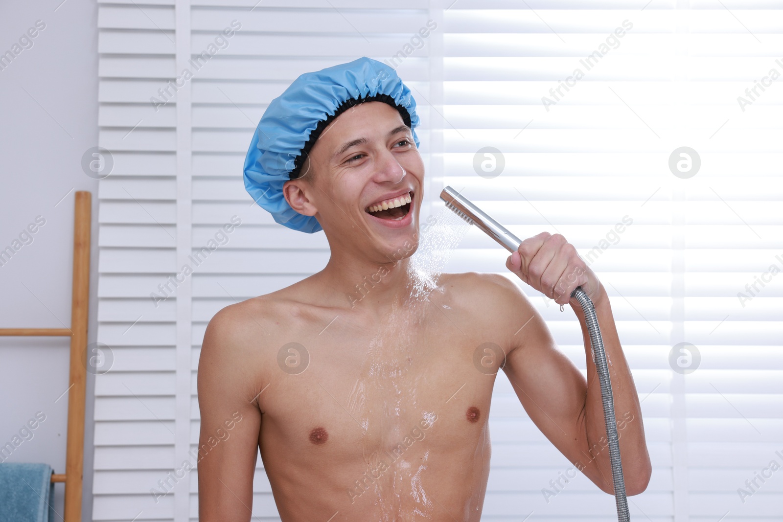 Photo of Man with cap taking shower in bathroom