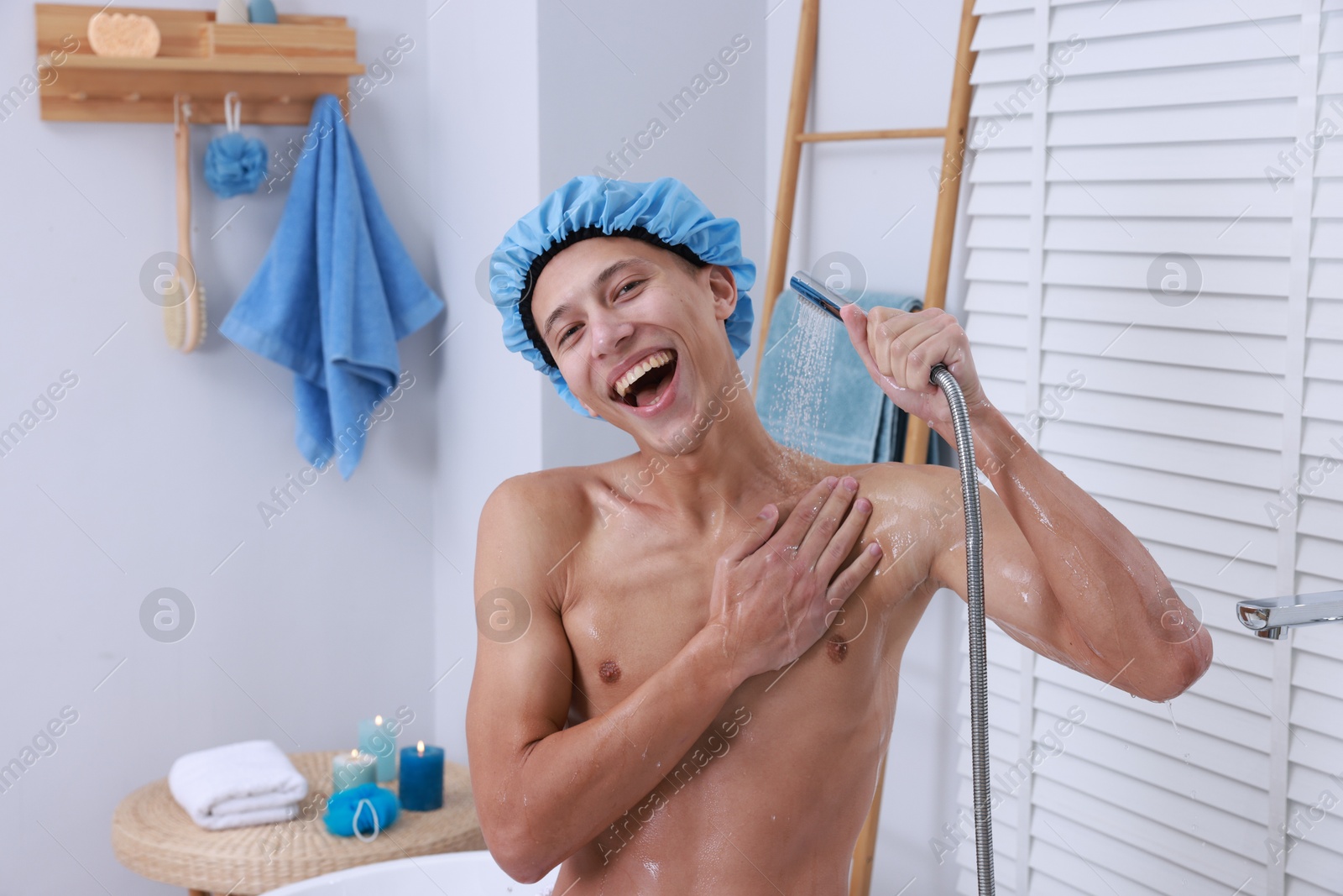 Photo of Man with cap taking shower in bathroom