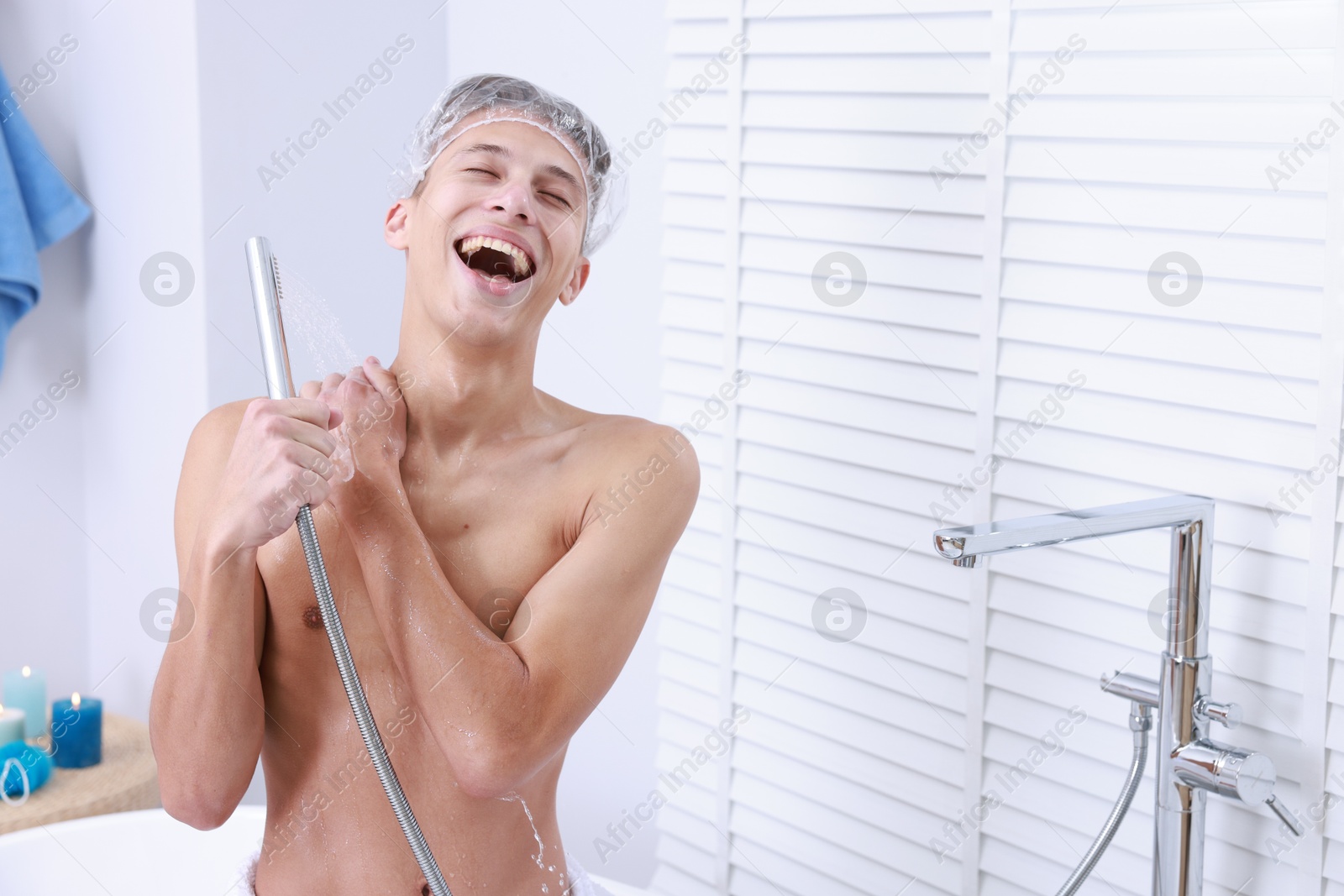 Photo of Man in cap taking shower in bathroom