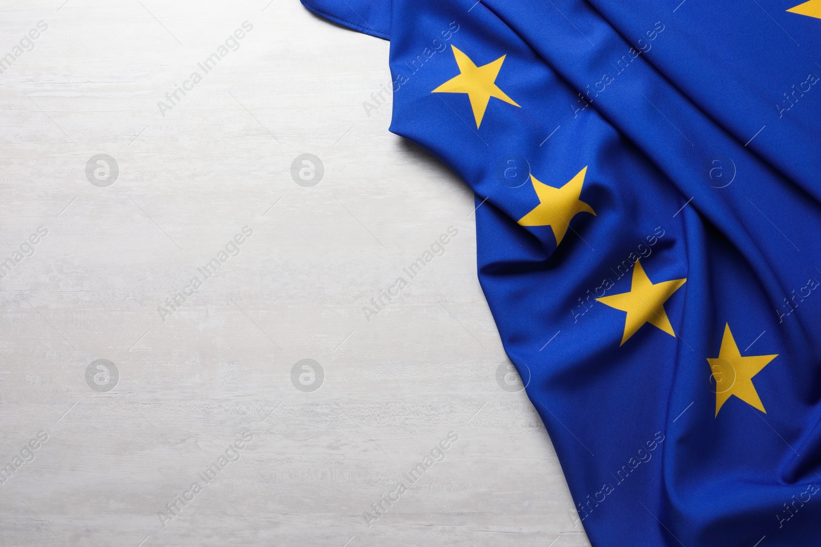 Photo of Flag of European Union on white textured background, above view. Space for text