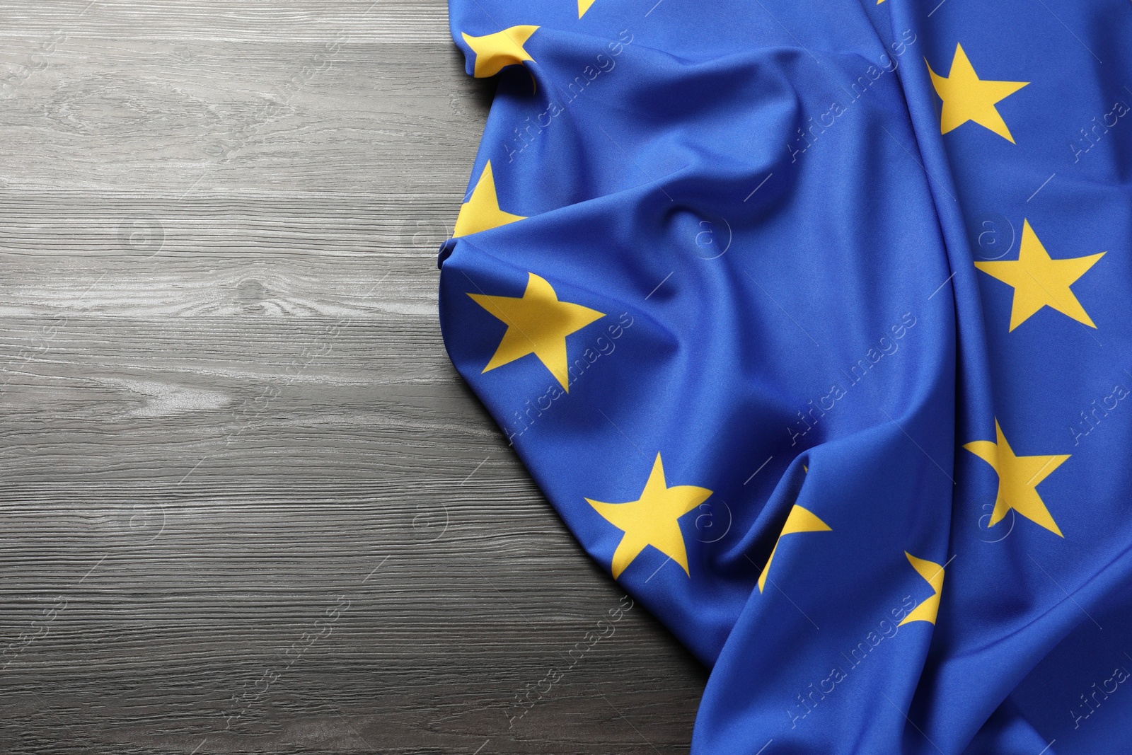 Photo of Flag of European Union on wooden background. Space for text