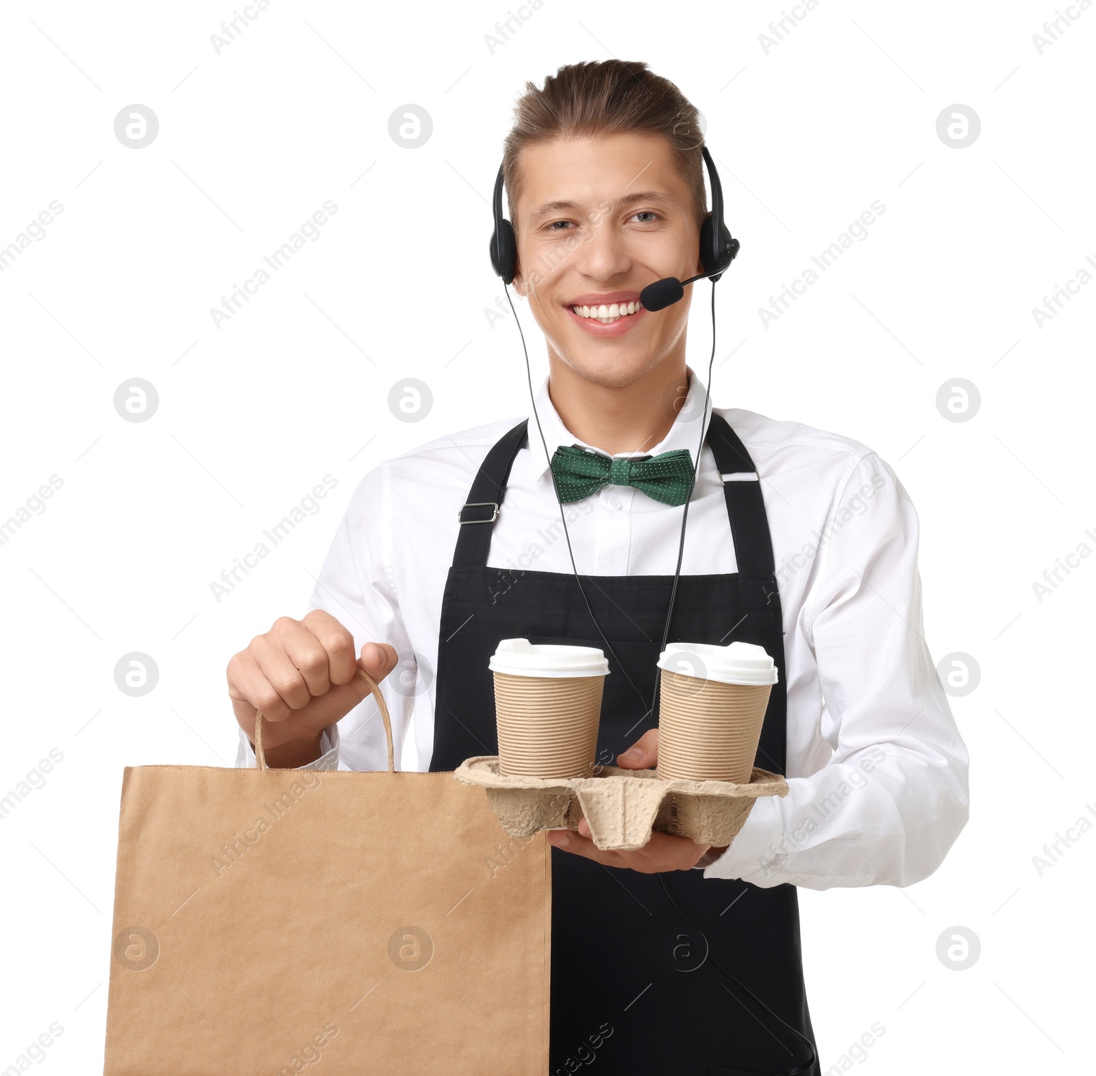 Photo of Fast-food worker with paper bag and cups on white background