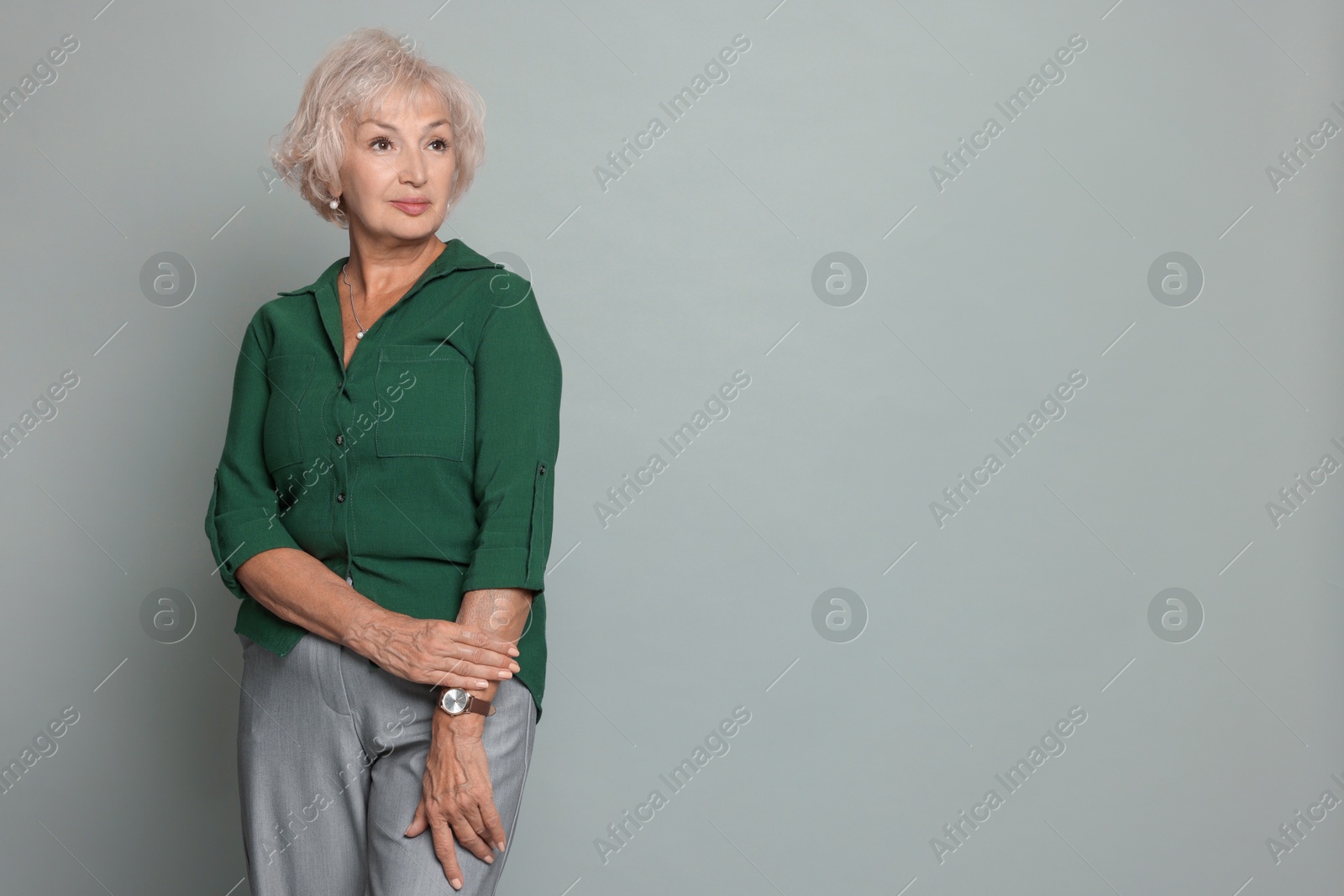 Photo of Portrait of beautiful senior woman on light grey background, space for text