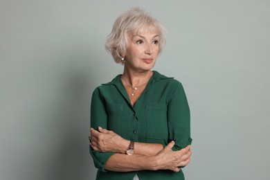 Photo of Portrait of beautiful senior woman on light grey background