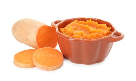 Photo of Tasty mashed sweet potato in pot and cut vegetable isolated on white