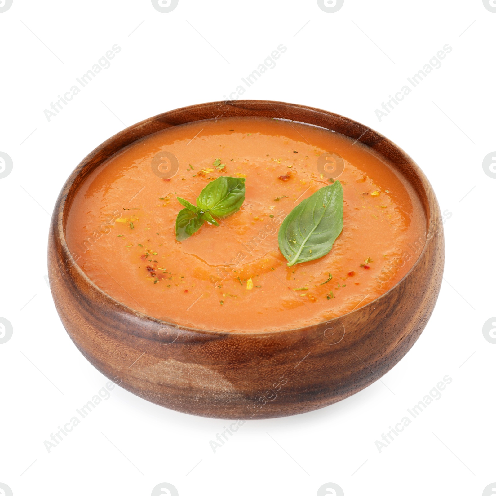 Delicious sweet potato soup with spices and basil in bowl isolated on white Photo of Delicious sweet potato soup with spices and basil in bowl isolated on white