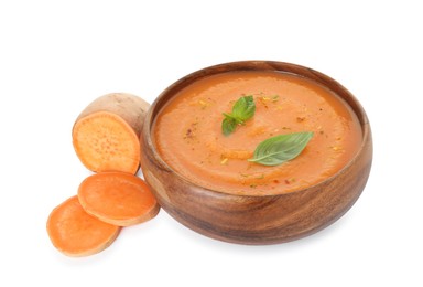 Photo of Delicious sweet potato soup with spices in bowl and cut vegetable isolated on white