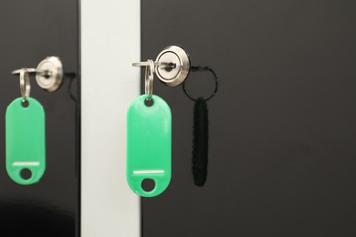 Photo of Modern lockers with bright keys, closeup view