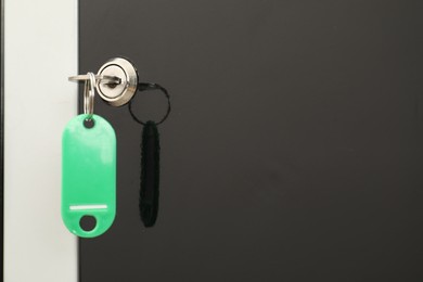 Photo of Modern locker with bright key, closeup view