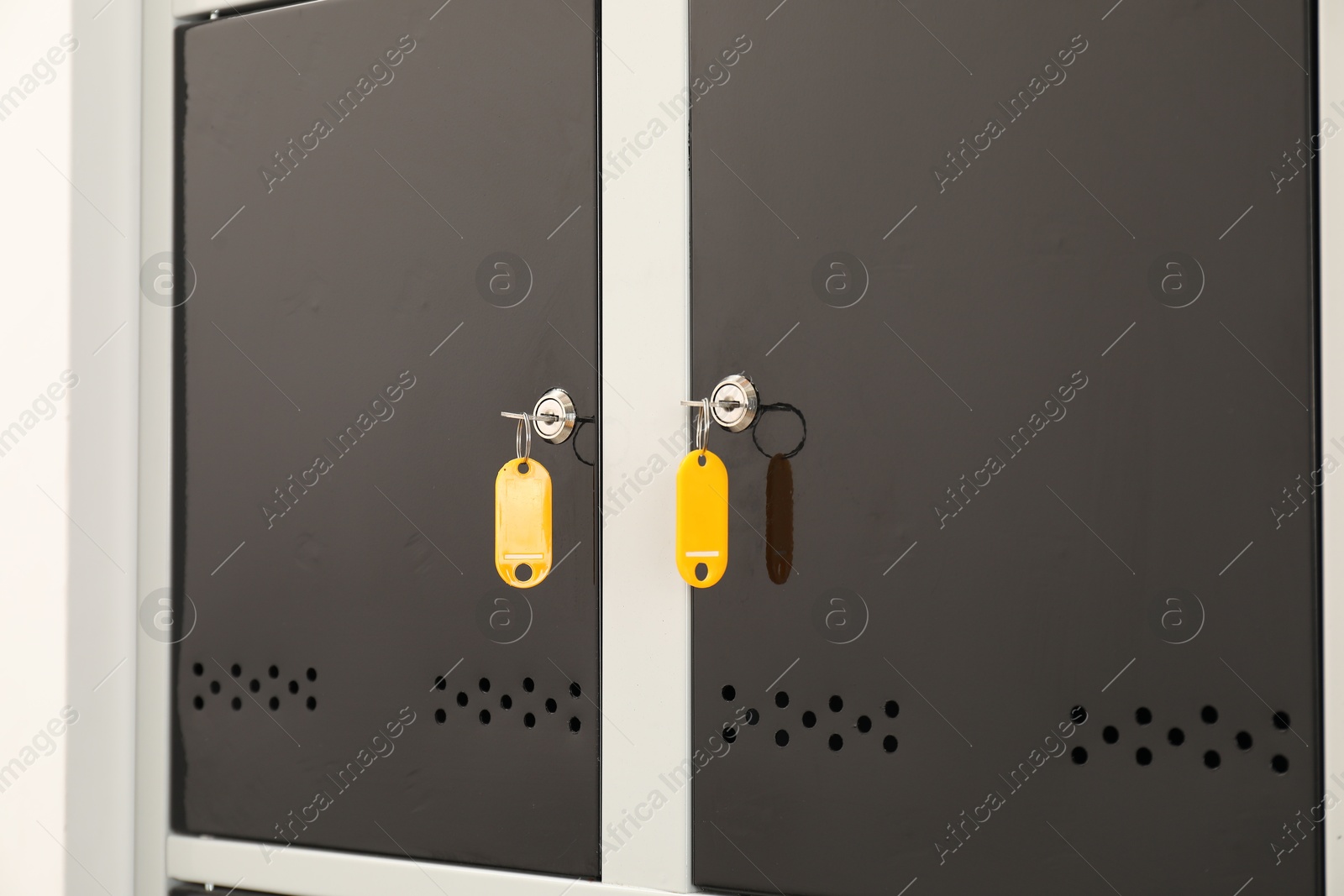 Photo of Modern lockers with bright keys, closeup view