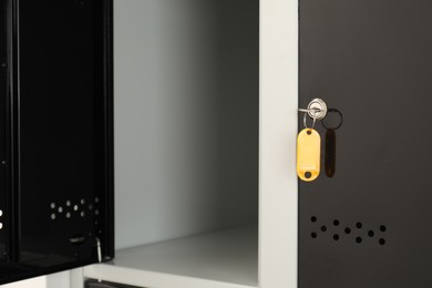 Photo of Modern lockers with bright key indoors, closeup