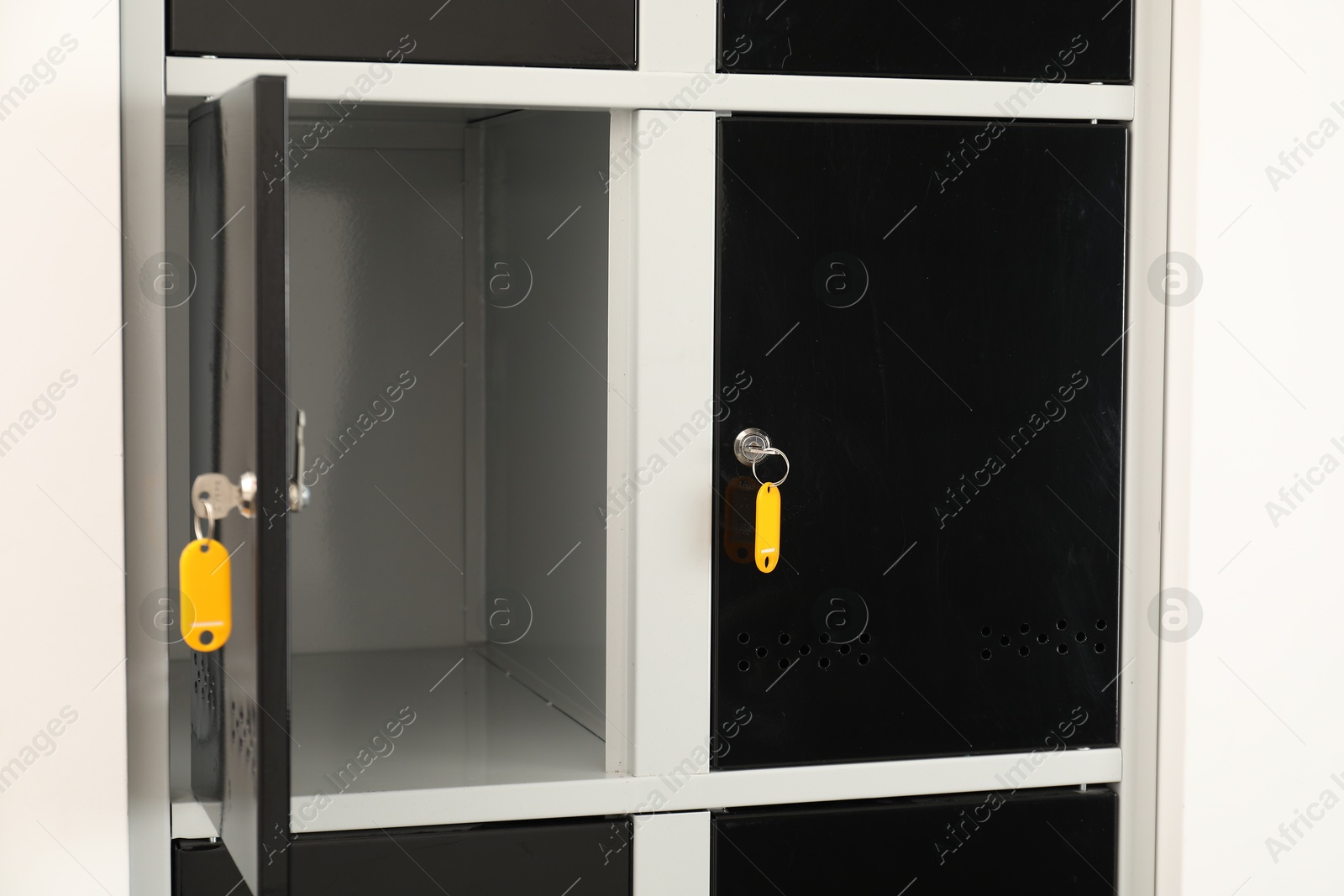 Photo of Modern lockers with bright keys indoors, closeup