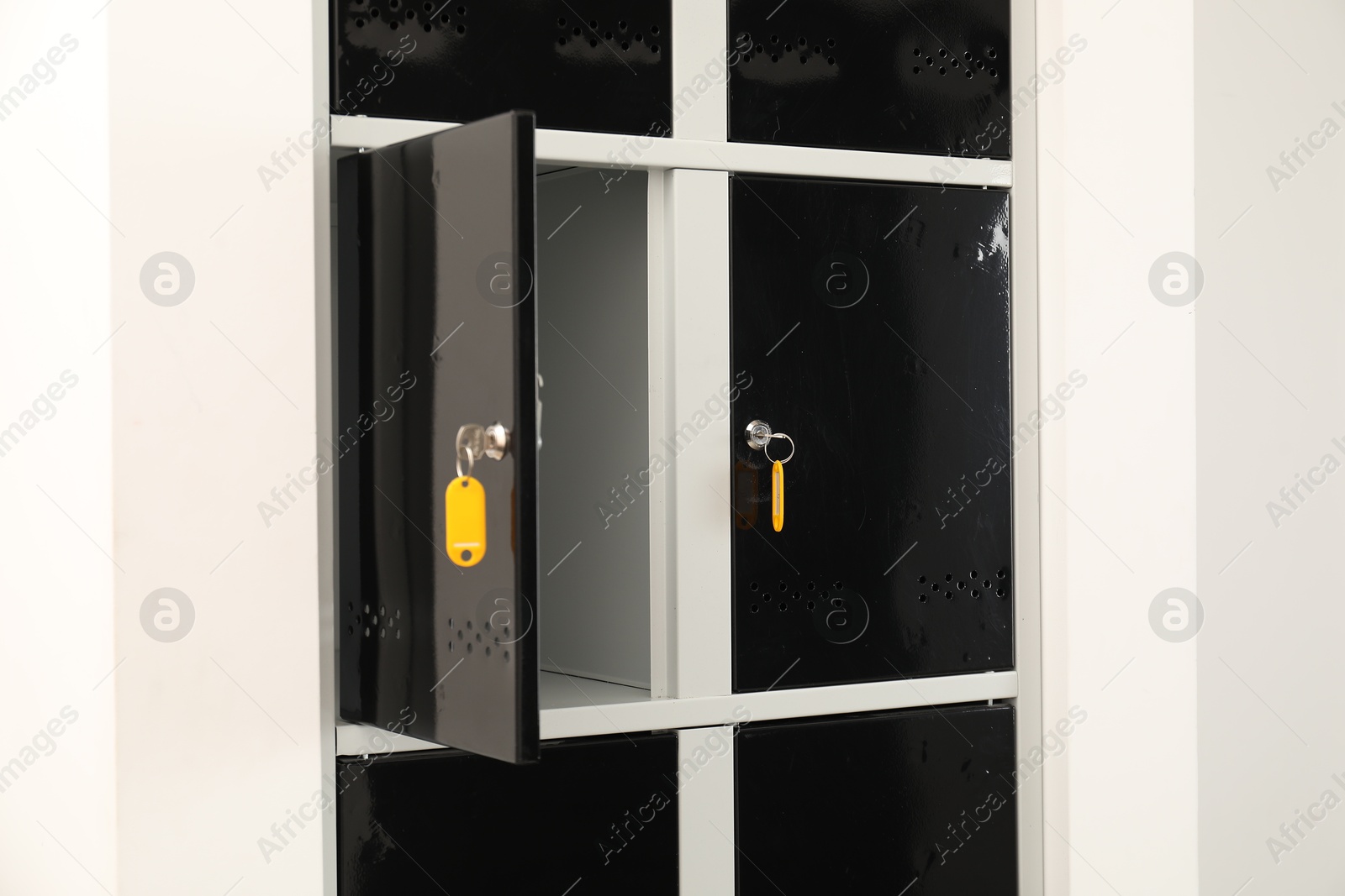 Photo of Modern lockers with bright keys indoors, closeup