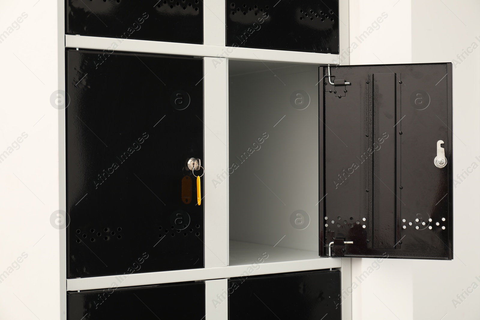 Photo of Modern lockers with bright key indoors, closeup