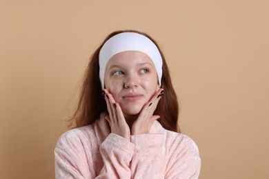 Photo of Teenage girl with headband on beige background