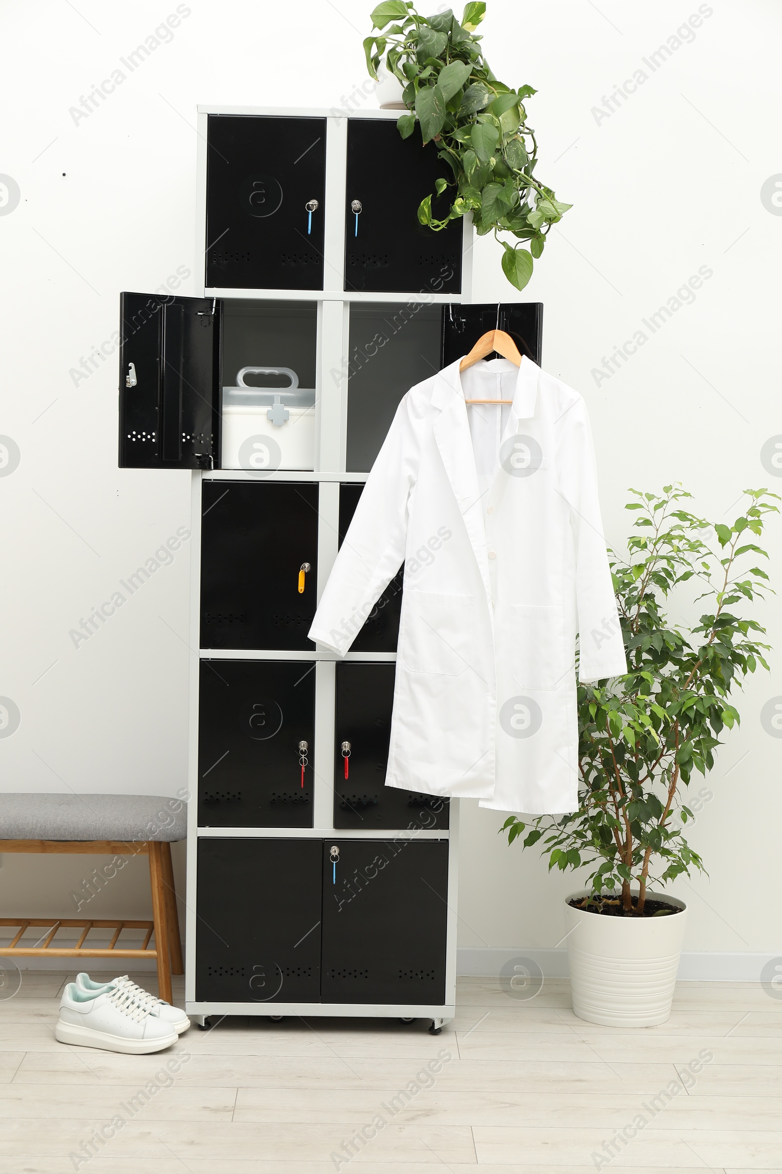 Photo of Medical personnel uniform on locker in changing room