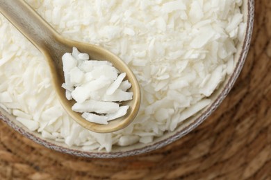 Photo of Soy wax in bowl on wicker mat, top view