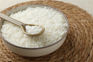 Photo of Soy wax in bowl on wicker mat, closeup