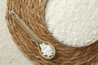 Photo of Soy wax in bowl on white textured table, top view