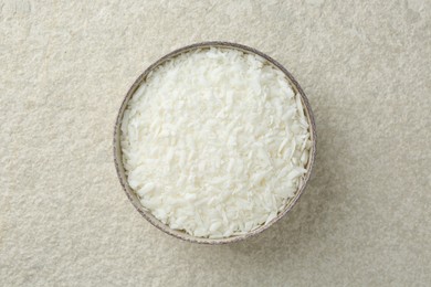 Photo of Soy wax in bowl on white textured table, top view