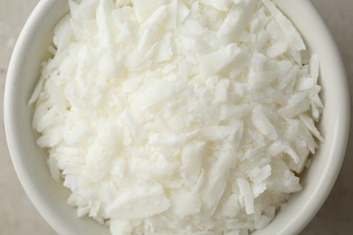 Soy wax in bowl on light grey table, top view