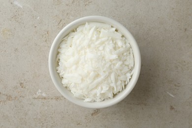 Soy wax in bowl on light grey table, top view