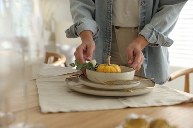 Photo of Woman setting table for dinner at home, closeup