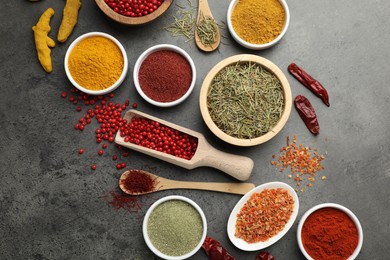 Photo of Different aromatic spices on grey table, flat lay