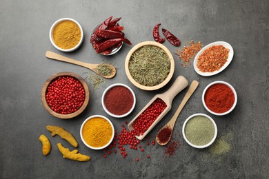 Photo of Different aromatic spices on grey table, flat lay