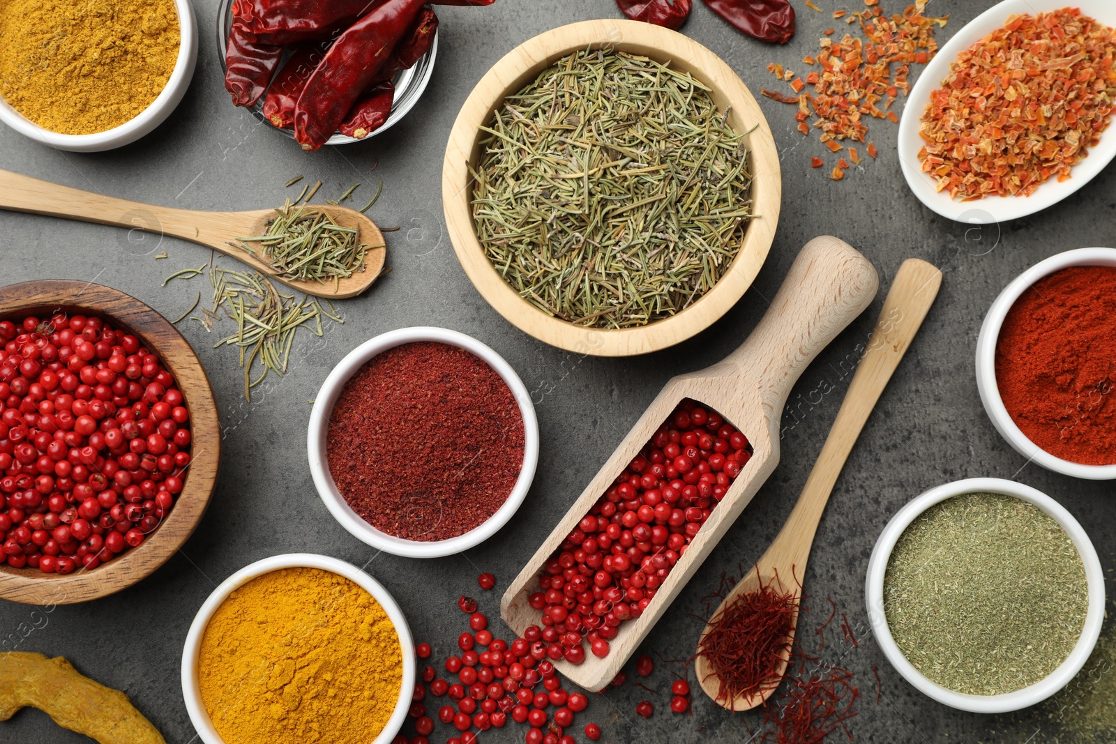 Photo of Different aromatic spices on grey table, flat lay